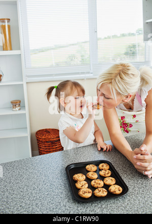 Pretty mother baking cookies with her daughter Stock Photo