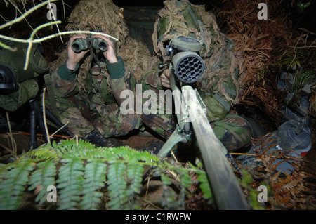 A British Army sniper team dressed in ghillie suits. Stock Photo