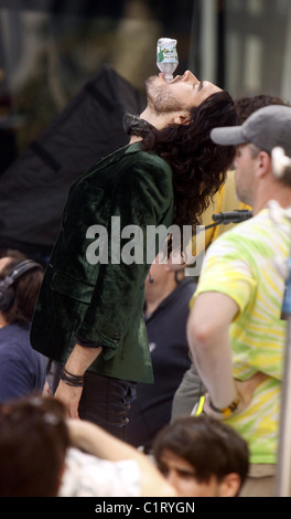 Russell Brand as character Aldous Snow, filming the movie, 'Get Him to The Greek' at Rockefeller Plaza, drinks a half pint of Stock Photo