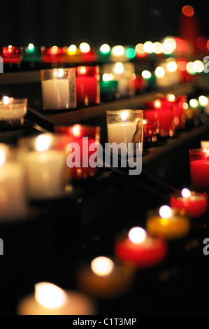 Votive candles burning in church Stock Photo