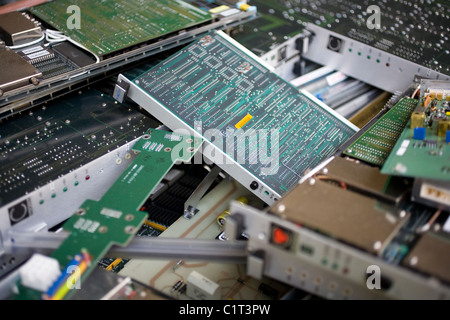 Old disused computer circuit boards in a pile waiting for recycling Stock Photo
