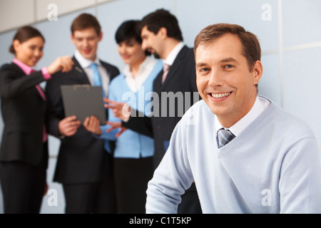 Photo of happy man looking at camera in working environment Stock Photo