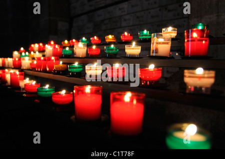 Votive candles burning in church Stock Photo