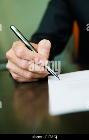 Person signing paperwork, cropped Stock Photo