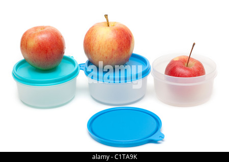 Three apples and plastic containers on white background Stock Photo