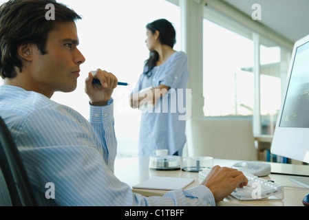 Man working on computer at home Stock Photo