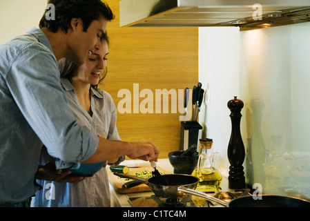 Couple cooking together Stock Photo