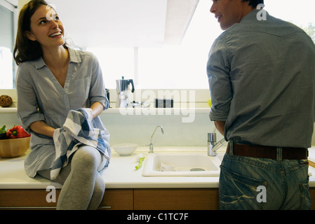 Couple washing dishes together Stock Photo