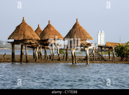 Island composed of shells with granaries on stilts out in the sea to protect from fire, Joal Fadiouth, Senegal Stock Photo