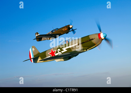 A Soviet Yakovlev Yak-3 and a P-51A Mustang in flight over Chino, California. Stock Photo