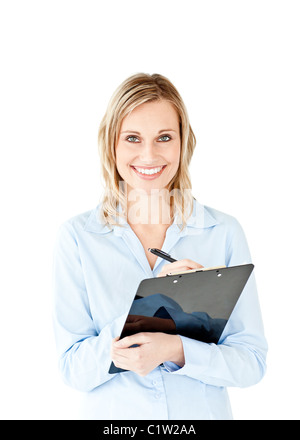 Glowing young businesswoman taking notes on her clipboard Stock Photo