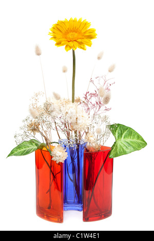 Bouquet from dry herb and yellow gerbera t in colour glass vase on white background Stock Photo