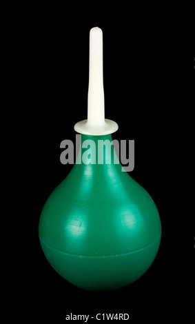 Green enema with white adjutage insulated on black background Stock Photo