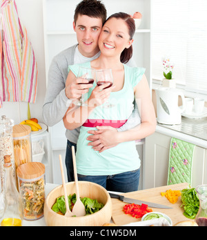 Affectionate couple drinking wine in the kitchen Stock Photo