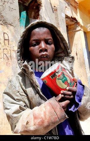 Young Talibé (students from a koranic school) beg on the streets of Saint Louis, Senegal Stock Photo