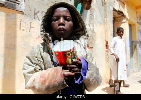 Young Talibé (students from a koranic school) beg on the streets of Saint Louis, Senegal Stock Photo