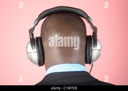 Rear view of African American Male wearing headphones Stock Photo