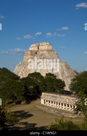 The Pyramid of the Magician (Pirámide del Adivino) rises over jungle in the Maya City of Uxmal, Yucatan Peninsula, Mexico. Stock Photo