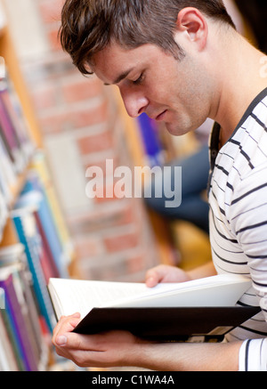 Serious young man reading a book Stock Photo