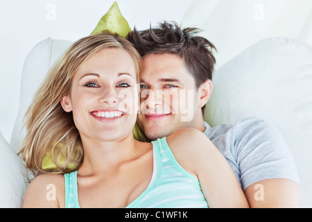 Portrait of an attractive couple hugging and relaxing on the sofa Stock Photo