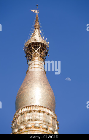 Top of the main stupa in the biggest Buddhist temple Shwedagon pagoda decorated with gold, diamonds and ruby jewels, Rangoon Stock Photo