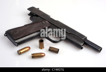 The ubiquitous Colt .45 automatic service pistol. Empty cases and live ammo. Stock Photo