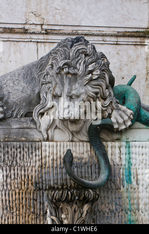 marble lion and bronze snake, fountain fragment Stock Photo