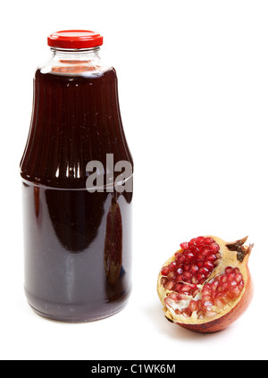 Bottle of juice and ripe piece grenade on white background Stock Photo