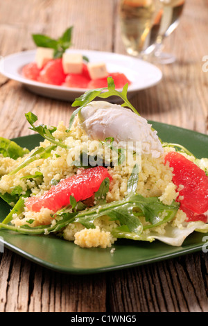 Couscous with red orange and rocket, poached egg on top Stock Photo