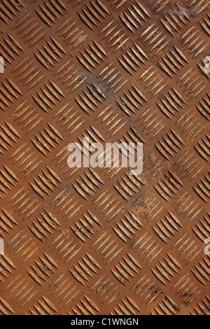 Vertical shot of some old rusty checker plate metal. Stock Photo