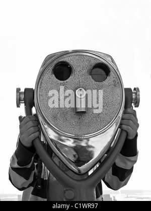 Tourist looking through sightseeing viewer. Stock Photo