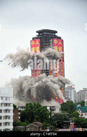 Abandoned tower block demolished An abandoned tower block in Zhongshan, China is demolished on 13 August (09). The building was Stock Photo