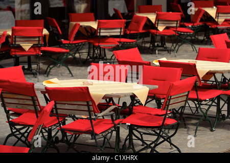 Red padded chairs in a restaurant front garden, Malbun, Liechtenstein FL Stock Photo