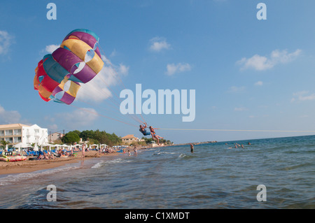 Corfu, Greece. October. View south along the beach at Agios Georgios, known as Saint George South. Watersport. Parascending. Stock Photo