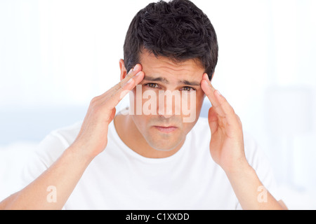 Exhausted man suffering from a headache Stock Photo