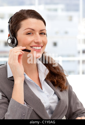 Smiling woman talking on the headphones Stock Photo