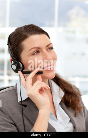 Pensive businesswoman talking on the phones using headphones Stock Photo