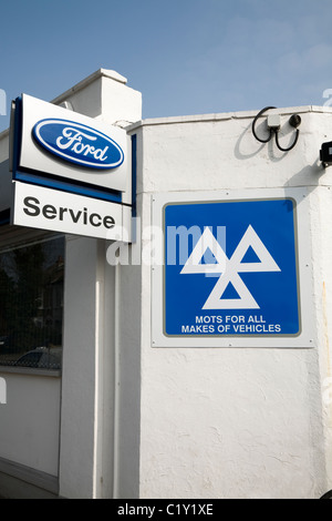 MOT / MOTs sign / logo at a Ford garage which is also a Ministry of Transport car and vehicle testing and service station. Stock Photo