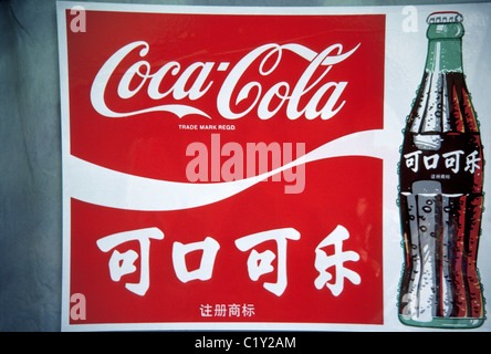 World-renowned Coca-Cola is advertised with its brand name printed in English letters and Chinese characters on a sign in Beijing, China (PRC). Stock Photo