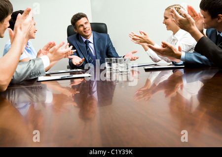 Photo of happy business partners applauding to confident leader at meeting Stock Photo