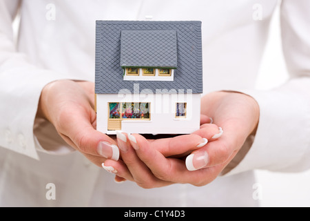 Close-up of toy house model in female hands Stock Photo