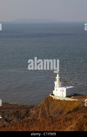 Hartland Point Lighthouse, with Lundy Island in the distance. Devon Stock Photo