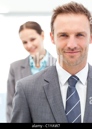 Confident businessman and businesswoman posing together in line Stock Photo