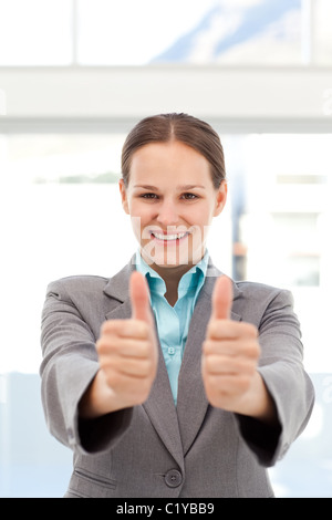 Proud businesswoman doing thumbs up Stock Photo