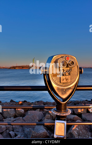 Commercial binoculars focused on the Statue of Liberty from Liberty State Park in New Jersey at sundown Stock Photo
