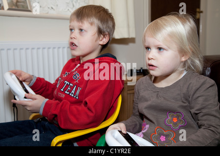 Two young children playing the Nintendo Wii gaming console Nottingham England UK Stock Photo