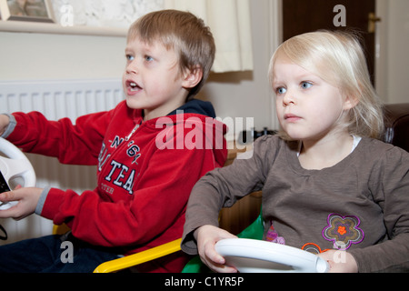 Two young children playing the Nintendo Wii gaming console Nottingham England UK Stock Photo