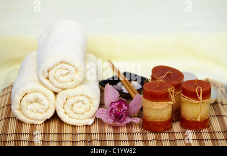 Still life on a theme a spa - a candle, mat, towels Stock Photo