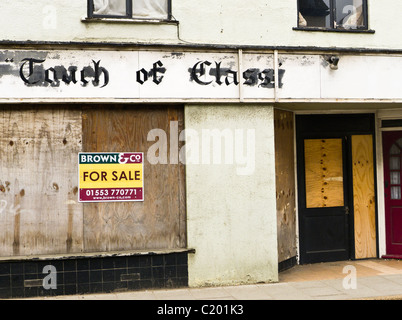 A boarded up shop front for sale in King's Lynn. Shop had been called 'Touch of Class'. Stock Photo