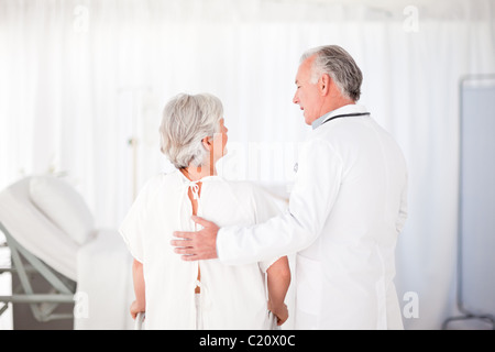 Doctor helping his patient to walk Stock Photo